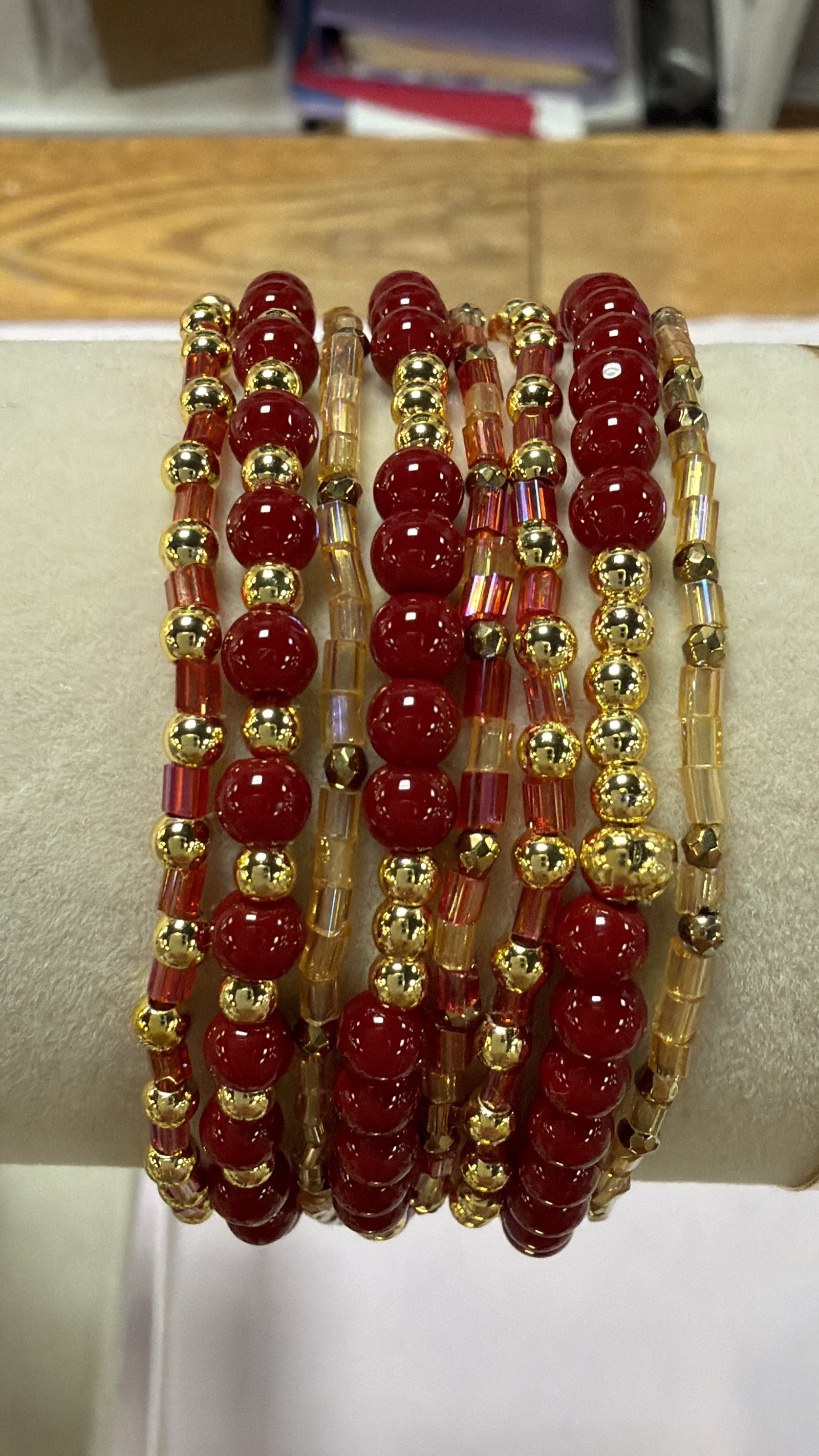 Red and gold beaded bracelet detail