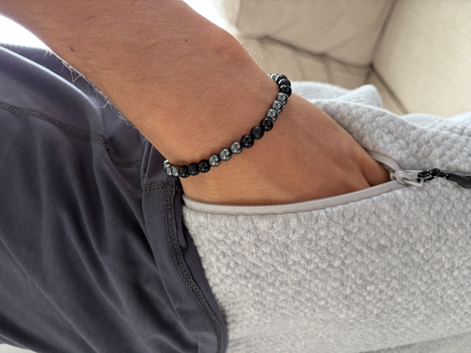 Men's onyx and hematite stretch bracelet on a wrist